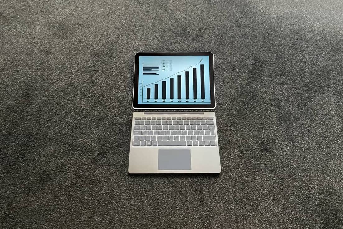Laptop am Boden zeigt steigende Graphen